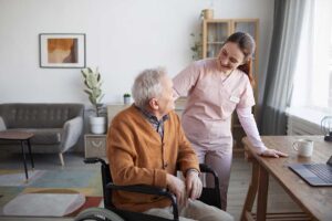 Social worker speaking with an assisted living resident and family member at a care planning table.